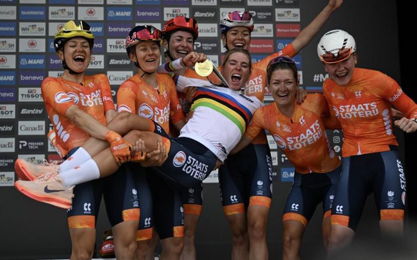 First-placed Demi Vollering of the Netherlands and teammtaes celebrate on the podium after the Women's Elite Road Race at the 2026 Union Cycliste Internationale (UCI) Road World Championships in Montreal, Quebec, on September 26, 2026.  Andrej Ivanov / AFP