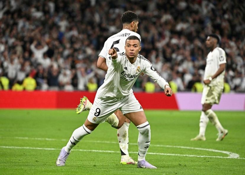 Real Madrid's French forward #09 Kylian Mbappe celebrates after Real Madrid's English midfielder #05 Jude Bellingham scored his team's second goal during the Spanish Copa del Rey (King's Cup) semi-final second leg football match between Real Madrid CF and Real Sociedad at the Santiago Bernabeu stadium in Madrid on April 1, 2025.  JAVIER SORIANO / AFP