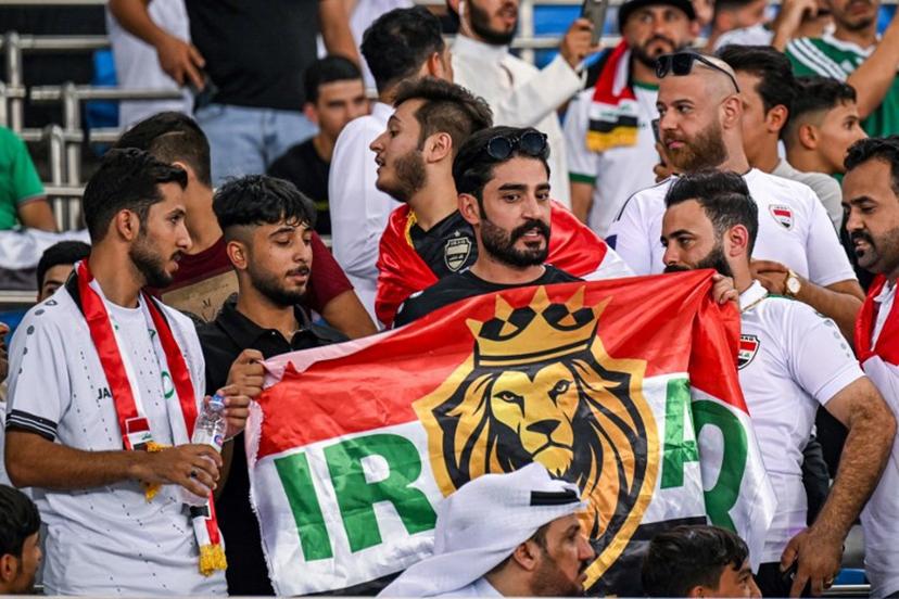 An Iraq supporter cheers for his team with a stylised national flag before the 2026 FIFA World Cup Asian qualification football match between Kuwait and Iraq at Jaber al-Ahmad International Stadium in Kuwait City on September 10, 2024.  YASSER AL-ZAYYAT / AFP
