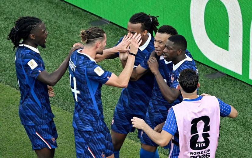 France's forward #10 Kylian Mbappe celebrates with teammates after scoring his team's first goal from the penalty spot during the 2026 World Cup round of 16 football match between Paraguay and France at the Philadelphia Stadium in Philadelphia on July 4, 2026.   Jewel SAMAD / AFP
