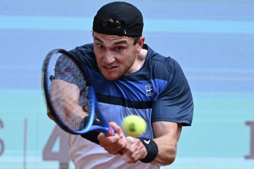 Great Britain's Jack Draper returns a backhand to Italy's Matteo Arnaldi during their 2025 ATP Tour Madrid Open tennis tournament quarter-final singles match at the Caja Magica in Madrid, on May 1, 2025.  JAVIER SORIANO / AFP