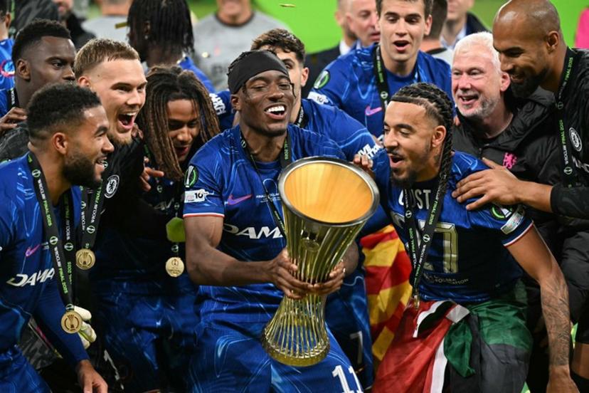Chelsea's English midfielder #11 Noni Madueke holds the trophy as Chelsea's players celebrate after the UEFA Conference League final football match between Real Betis and Chelsea FC in Wroclaw on May 28, 2025.   Sergei GAPON / AFP