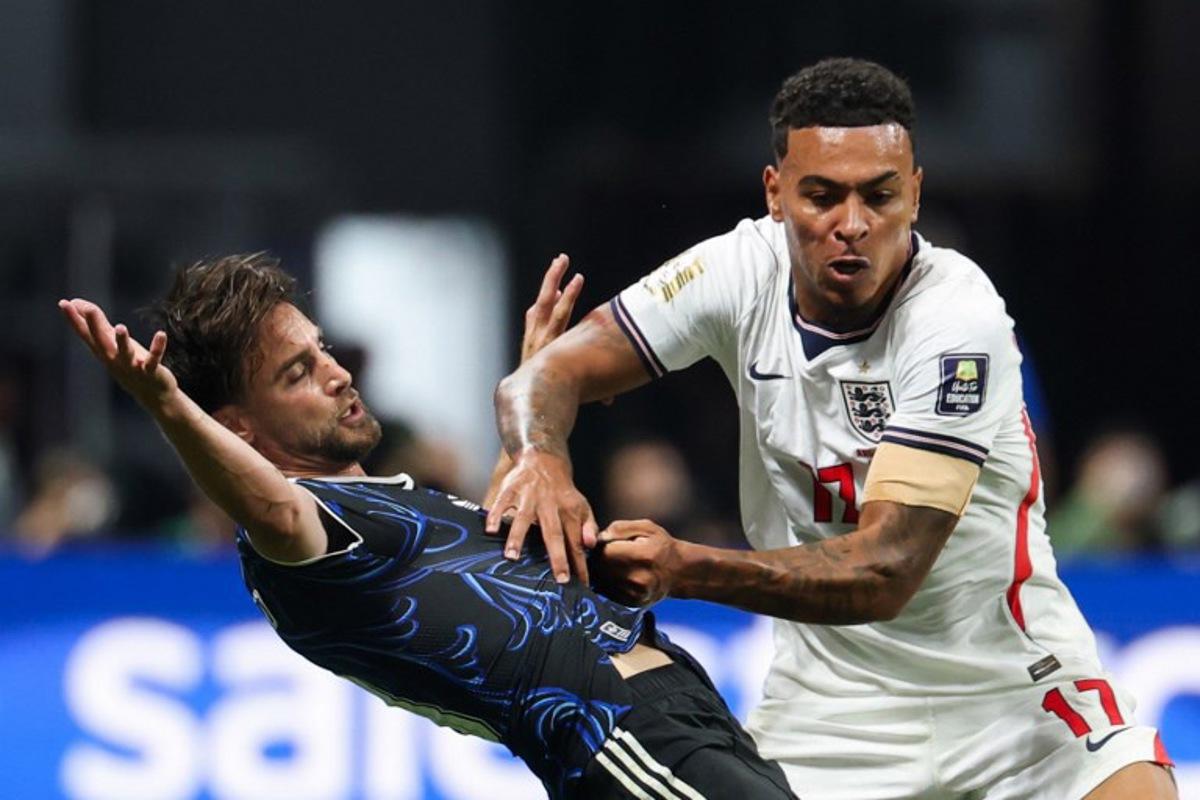 England's midfielder #17 Morgan Rogers (R) and Argentina's defender #03 Nicolas Tagliafico fight for the ball during the 2026 World Cup football tournament semi-final match between England and Argentina at the Atlanta Stadium in Atlanta on July 15, 2026.   Odd ANDERSEN / AFP