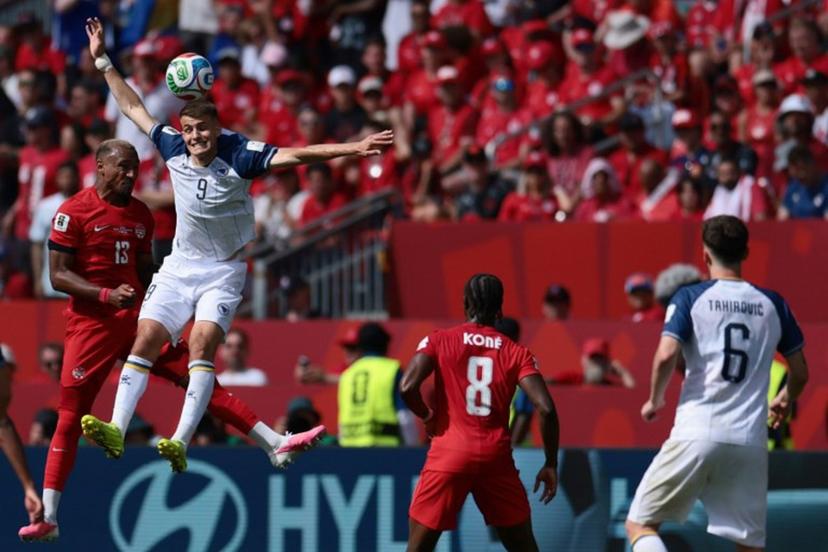 Canada's defender #13 Derek Cornelius (L) fights for the ball with Bosnia-Herzegovina's forward #09 Samed Bazdar (2ndL) during the 2026 World Cup Group B football match between Canada and Bosnia and Herzegovina at the Toronto Stadium in Toronto on June 12, 2026.  Cole Burston / AFP
