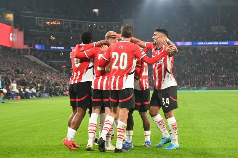 PSV's players celebrate after scoring their first goal during the UEFA Champions League 1st round day 2 football match between PSV Eindhoven (NED) and Sporting Lisbon (POR) at the The Philips Stadion, in Eindhoven, on October 1, 2024.  NICOLAS TUCAT / AFP