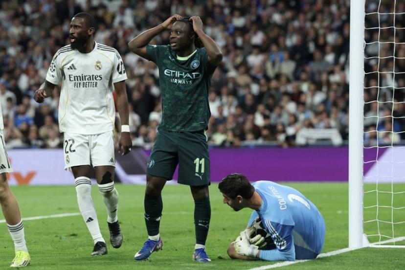 Manchester City's Belgian midfielder #11 Jeremy Doku (C) reacts after missing a chance to score during the UEFA Champions League last 16 first leg football match between Real Madrid CF and Manchester City at Santiago Bernabeu Stadium in Madrid on March 11, 2026.  Pierre-Philippe MARCOU / AFP