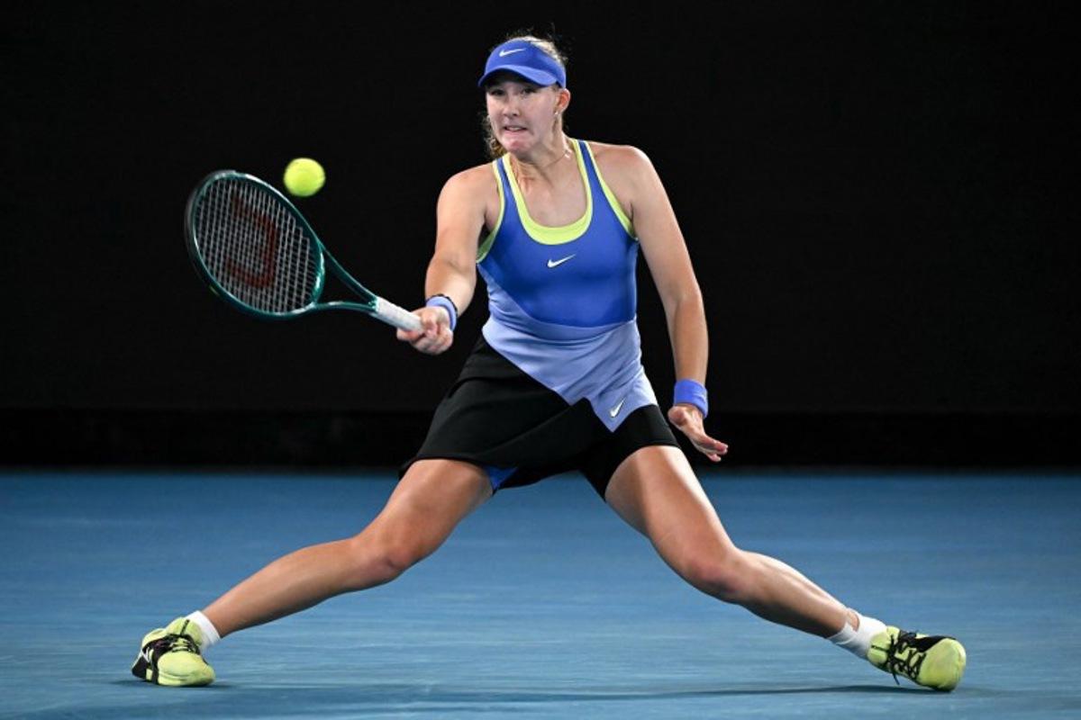 Russia's Mirra Andreeva hits a return to Romania's Elena-Gabriela Ruse during their women's singles match on day six of the Australian Open tennis tournament in Melbourne on January 23, 2026.  WILLIAM WEST / AFP