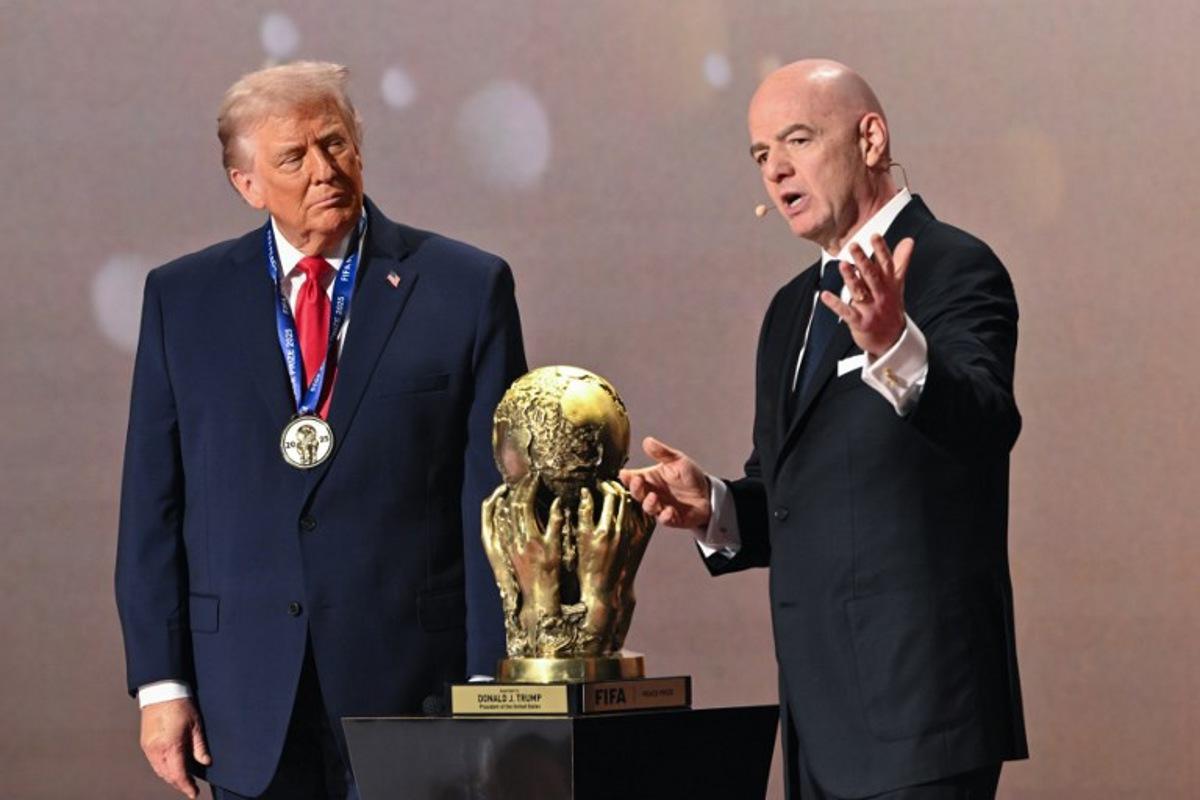 (L/R) US President Donald Trump looks on as he receives the FIFA Peace Prize from FIFA President Gianni Infantino during the draw for the 2026 FIFA Football World Cup taking place in the US, Canada and Mexico, at the Kennedy Center, in Washington, DC, on December 5, 2025.  Mandel NGAN / POOL / AFP