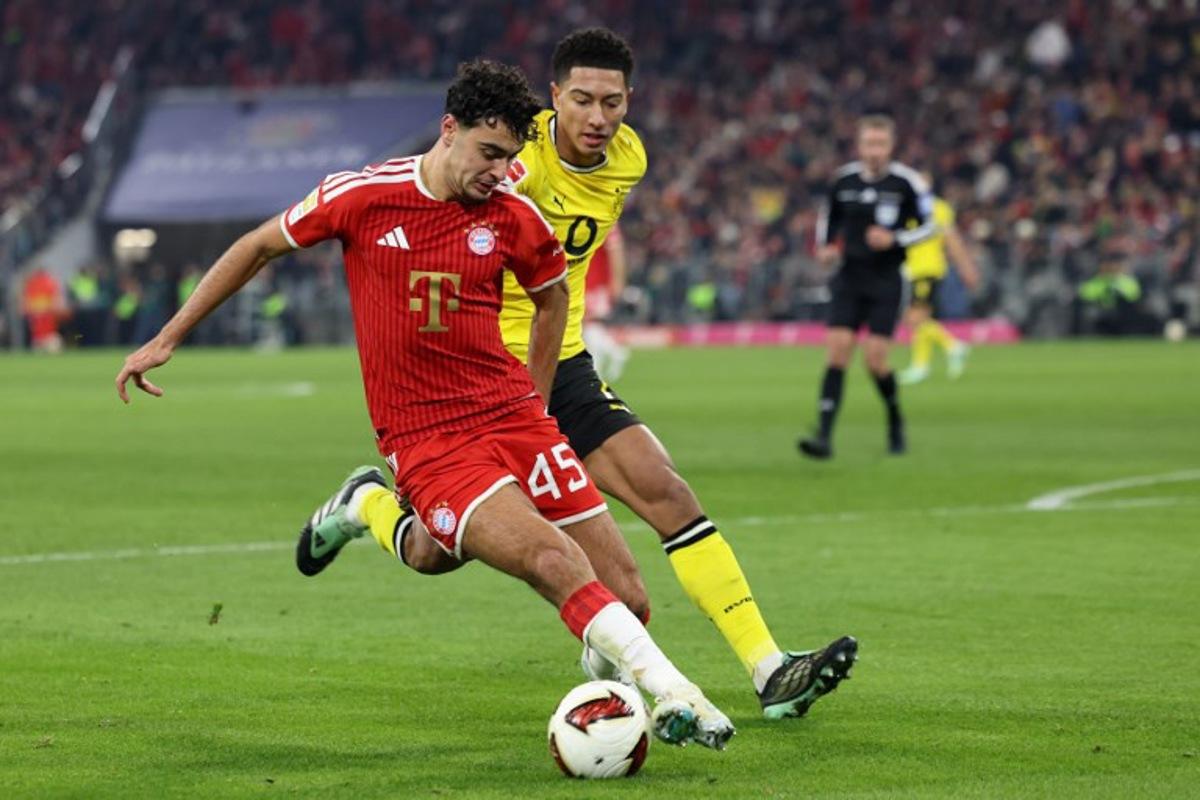 Bayern Munich's German midfielder #45 Aleksandar Pavlovic and Dortmund's English midfielder #07 Jobe Bellingham vie for the ball during the German first division Bundesliga football match between FC Bayern Munich and BVB Borussia Dortmund in Munich, southern Germany, on October 31, 2026.  Alexandra BEIER / AFP