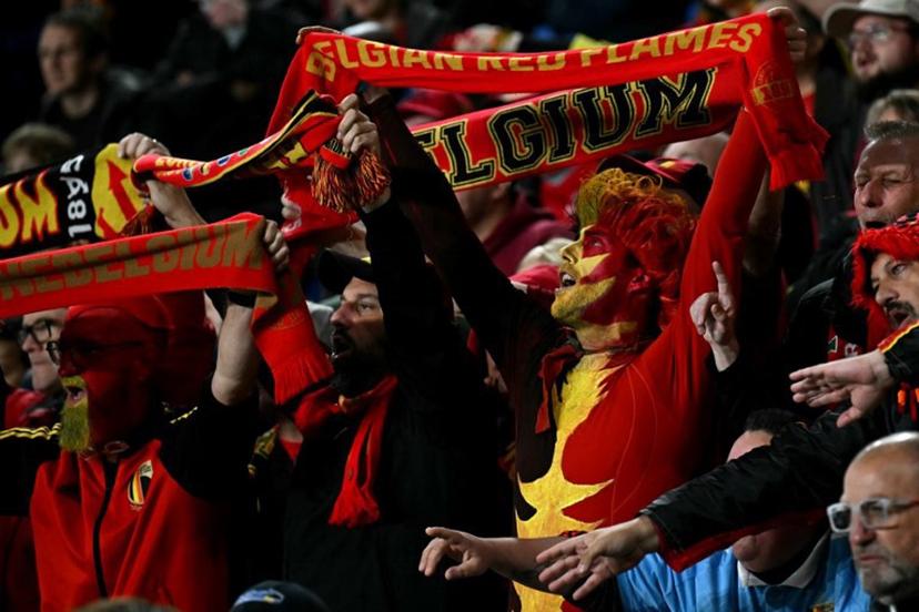 Fans holds aloft scarves during the 2026 World Cup Group J qualifier football match between Wales and Belgium, at Cardiff City Stadium, in Cardiff, on October 13, 2025.   Paul ELLIS / AFP