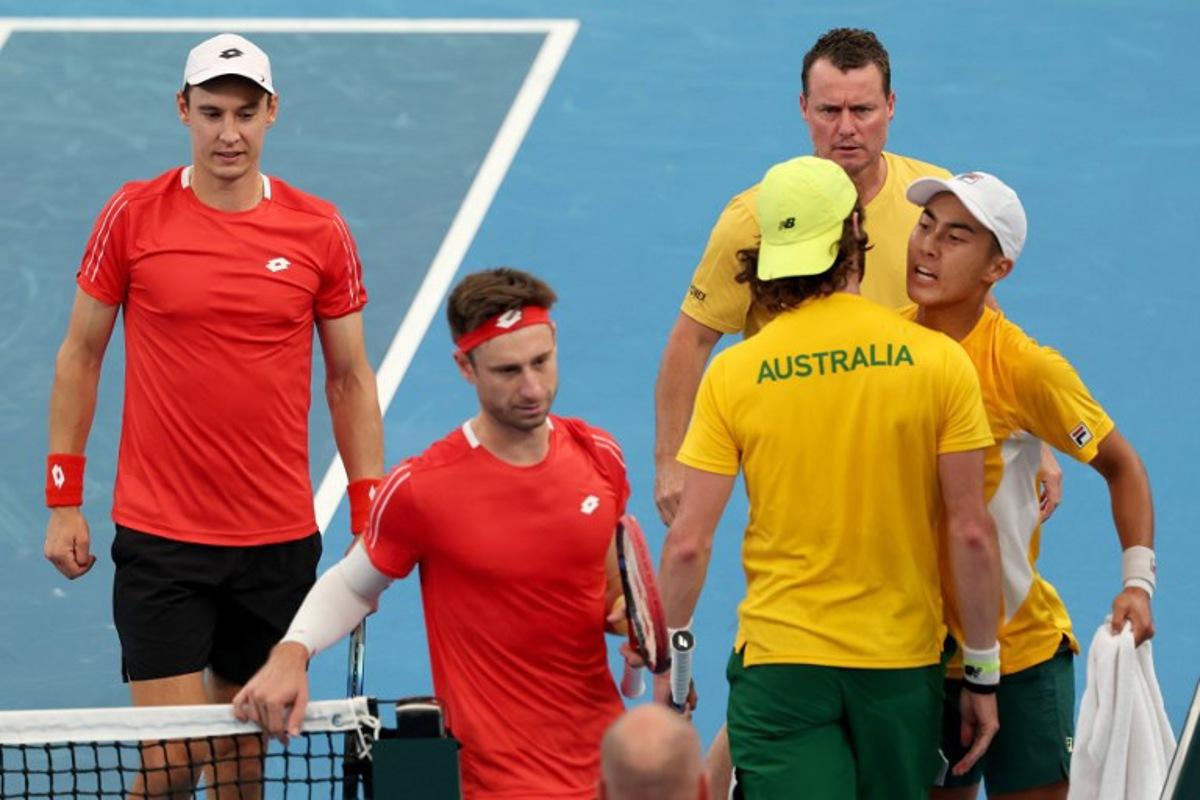 Australia's team captain Lleyton Hewitt (TOP) watches players Rinky Hijikata (R) and Jordan Thompson react after winning the second set against Belgium's Sander Gille and Joran Vliegen (L) during their Davis Cup second-round qualifier doubles tennis match at Ken Rosewall Arena in Sydney on September 14, 2025.  DAVID GRAY / AFP