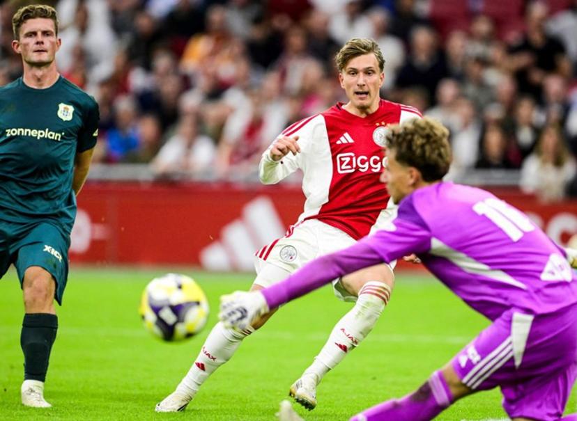 Ajax's Belgian forward #11 Mika Godts (C) eyes the ball during the Dutch Eredivisie football match between Ajax Amsterdam and and PEC Zwolle at the Johan Cruijff ArenA in Amsterdam on September 13, 2025.  Olaf Kraak / ANP / AFP