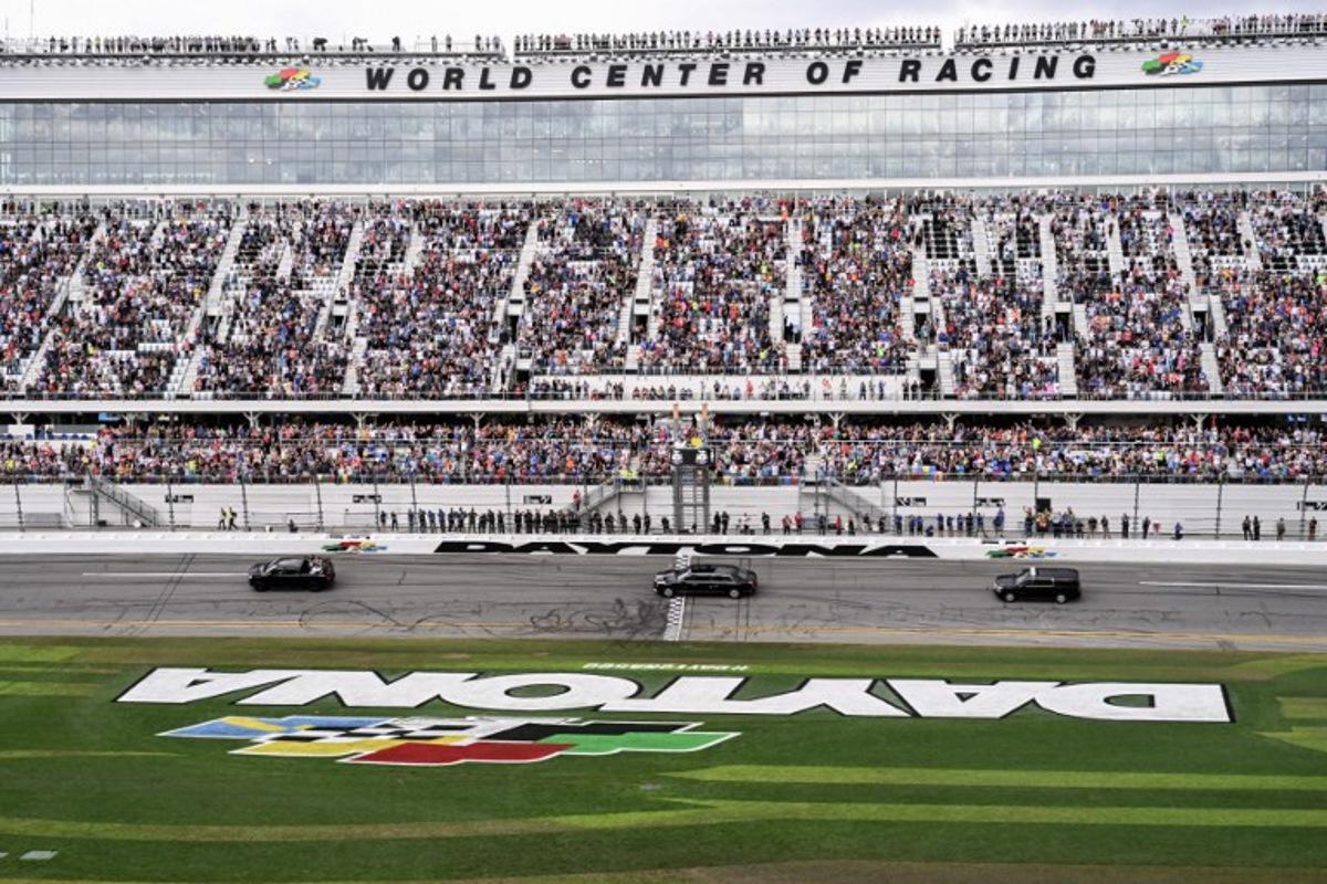The motorcade of US President Donald Trump does a lap around the track during the Daytona 500 NASCAR race at Daytona International Speedway in Daytona Beach, Florida, on February 16, 2025.   ROBERTO SCHMIDT / AFP