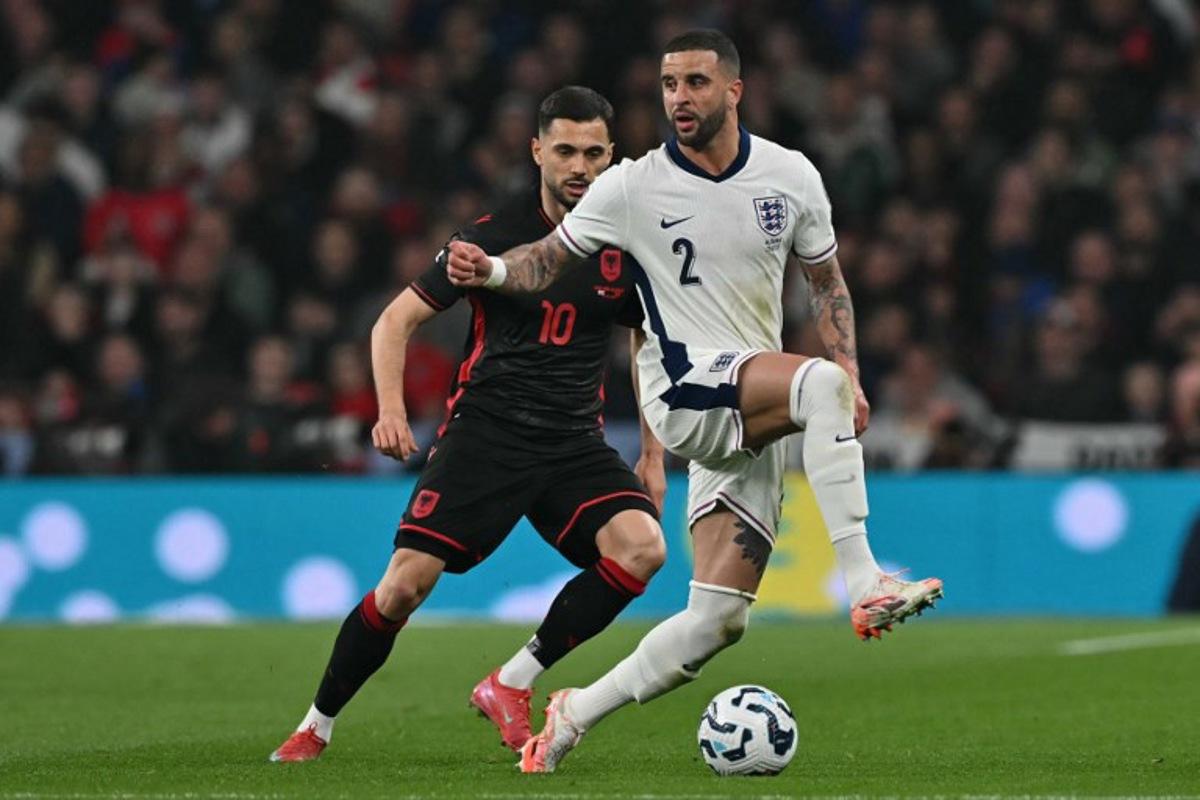 England's defender #02 Kyle Walker (R) vies with Albania's midfielder #10 Nedim Bajrami (L) during the 2026 World Cup Group K qualifier football match between England and Albania, at Wembley stadium in London, on March 21, 2025.   Glyn KIRK / AFP