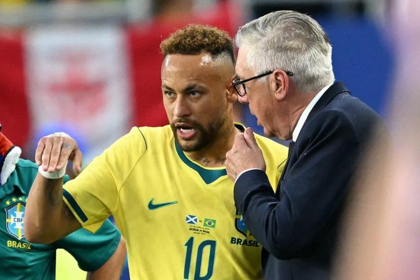 Brazil's Italian head coach Carlo Ancelotti talks to his forward #10 Neymar during the 2026 World Cup Group C football match between Scotland and Brazil at the Miami Stadium in Miami Gardens on June 24, 2026.   CHANDAN KHANNA / AFP