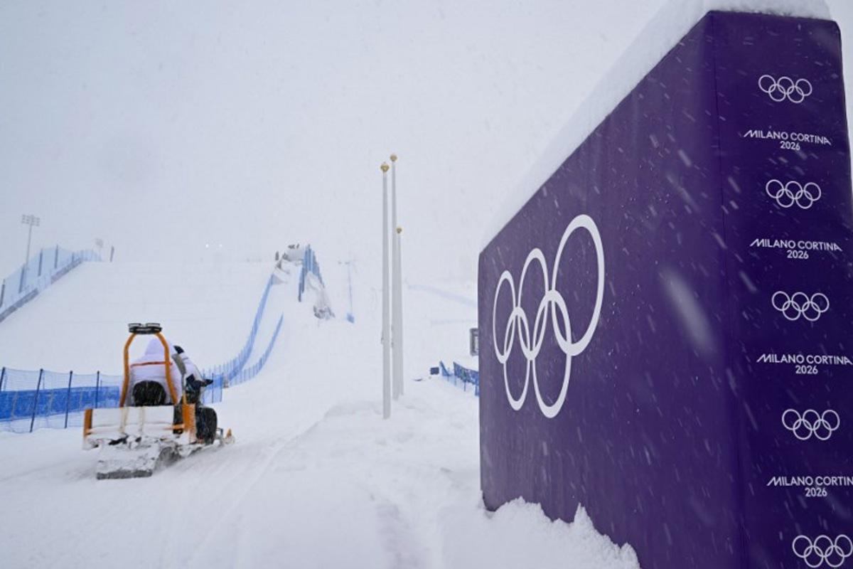 A snowmobile drives past a placard displaying olympic rings, shortly after the cancellation due to weather conditions of the snowboard women's slopestyle final run 1 during the Milano Cortina 2026 Winter Olympic Games at Livigno Snow Park, in Livigno (Valtellina), on February 17, 2026.  Kirill KUDRYAVTSEV / AFP