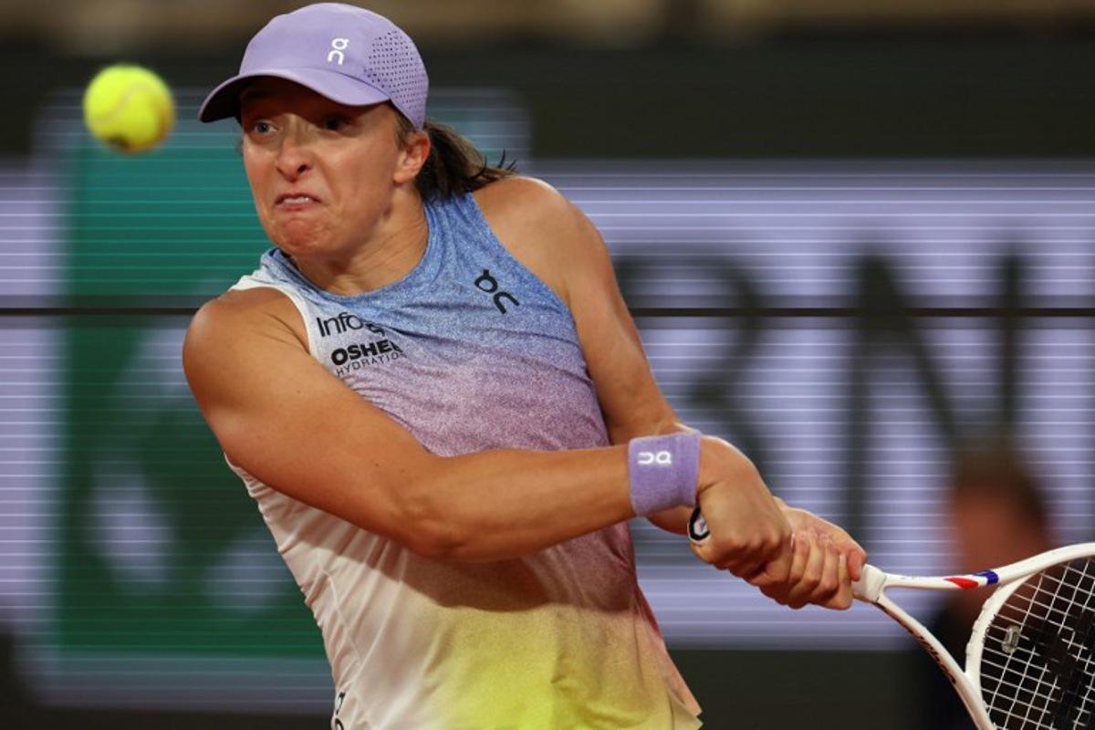 Poland's Iga Swiatek plays a backhand return to Belarus' Aryna Sabalenka during their women's singles semi-final match on day 12 of the French Open tennis tournament on Court Philippe-Chatrier at the Roland-Garros Complex in Paris on June 5, 2025.  Alain JOCARD / AFP