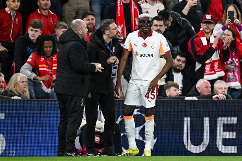Galatasaray's Nigerian forward #45 Victor Osimhen (R) receives medical treatment during the UEFA Champions League, round of 16 second leg football match between Liverpool and Galatasaray at Anfield in Liverpool, north-west England on March 18, 2026.  Paul ELLIS / AFP