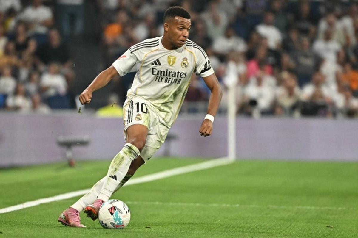 Real Madrid's French forward #10 Kylian Mbappe controls the ball during the Spanish league football match between Real Madrid CF and CA Osasuna at Santiago Bernabeu Stadium in Madrid on August 19, 2025.  Javier SORIANO / AFP
