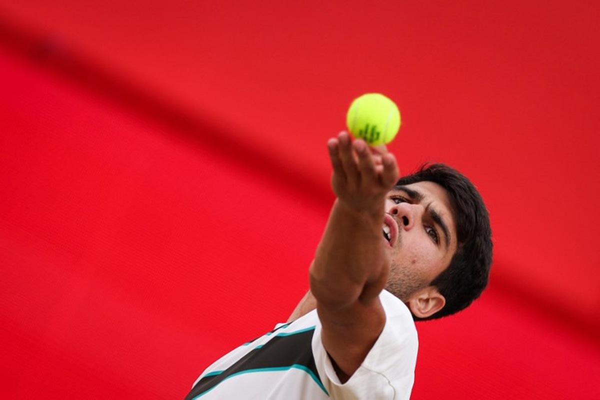 Spain's Carlos Alcaraz serves to Czech Republic's Jiri Lehecka  during their men's singles final tennis match at the HSBC ATP tennis Championships at Queen's Club in west London on June 22, 2025.  Adrian Dennis / AFP