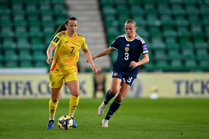 Belgium's forward #07 Hannah Eurlings runs with the ball from Scotland's Defender #03 Amy Muir during the Women's FIFA world cup league B, group 4, qualifier football match between Scotland and Belgium at Easter Road, in Edinburgh, Scotland, on April 14, 2026.  ANDY BUCHANAN / AFP