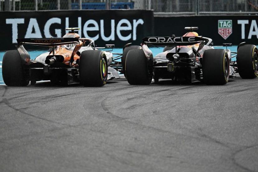 (L-R) McLaren's British driver Lando Norris and Red Bull Racing's Dutch driver Max Verstappen race during the 2025 Miami Formula One Grand Prix at Miami International Autodrome in Miami Gardens, Florida, on May 4, 2025.   Chandan Khanna / AFP