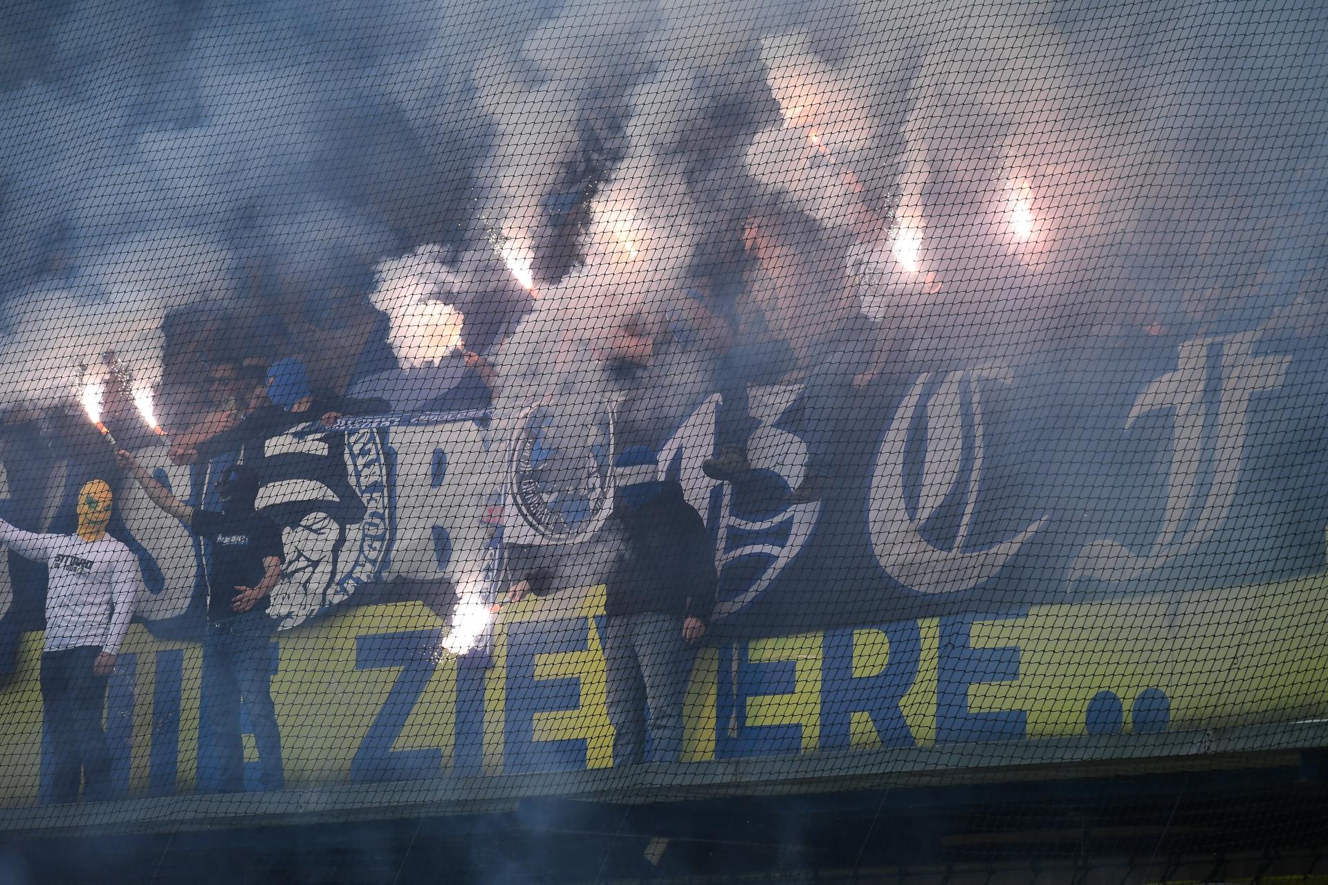 Supporters with fireworks and smoke bombs pictured during a soccer match between Sint-Truidense V.V. and KRC Genk, Sunday 28 September 2025 in Sint-Truiden, on day 9 of the 2025-2026 'Jupiler Pro League' first division of the Belgian championship. BELGA PHOTO JILL DELSAUX