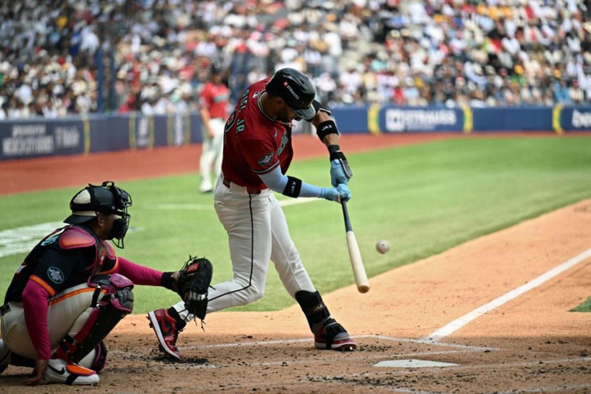 Arizona Diamondbacks' #12 Lourdes Gurriel Jr. swings in front of San Diego Padres' #12 Luis Campusano during the MLB World Tour Mexico City Series game between the Arizona Diamondbacks and the San Diego Padres at Alfredo Harp Helu Stadium in Mexico City on April 26, 2026.  YURI CORTEZ / AFP