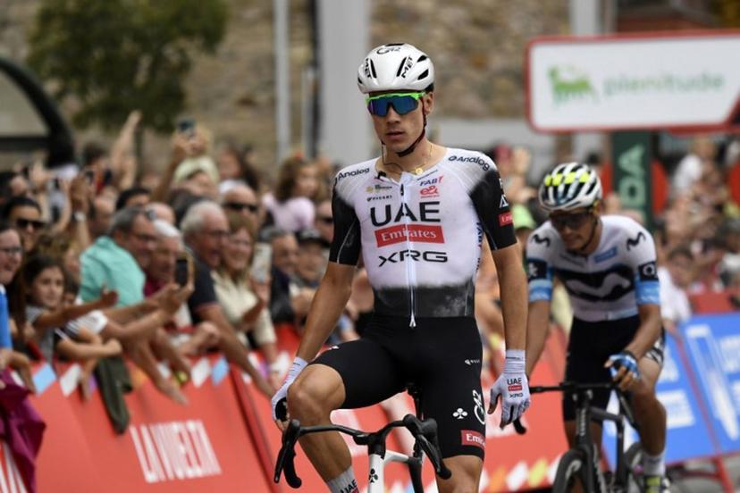 Team UAE's Spanish rider Juan Ayuso (L) crosses the finish line to win the 12th stage of the Vuelta a Espana, a 144.9 km race between Laredo and Corrales de Buelna, on September 4, 2025.  ANDER GILLENEA / AFP