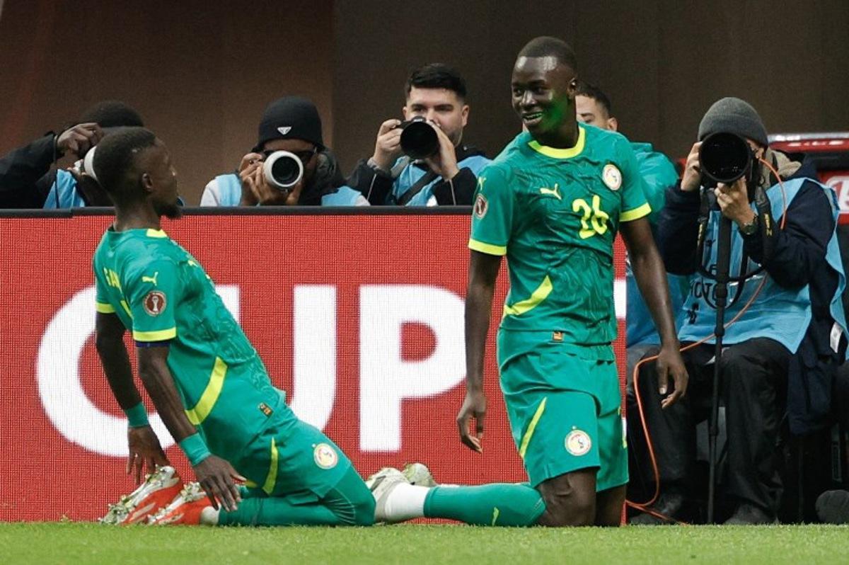 Senegal's midfielder #26 Pape Gueye (R) celebrates scoring his team's second goal during the Africa Cup of Nations (CAN) round of 16 football match between Senegal and Sudan at Grand Stadium in Tangiers on January 3, 2026.  Abdel Majid BZIOUAT / AFP