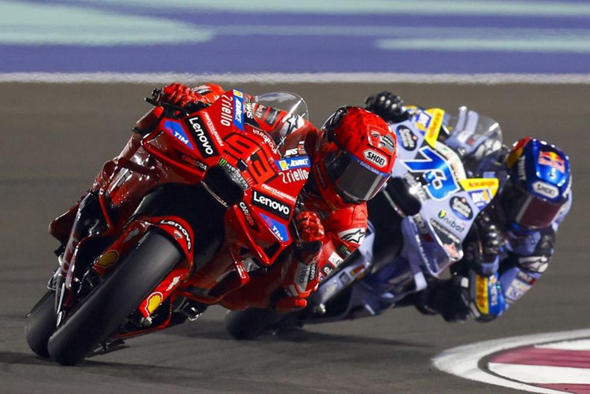 Ducati Lenovo's Spanish rider Marc Marquez and BK8 Gresini Racing MotoGP's Spanish rider Alex Marquez compete during the Qatar Moto GP Grand Prix sprint race at the Lusail International Circuit on April 12, 2025.  Karim JAAFAR / AFP