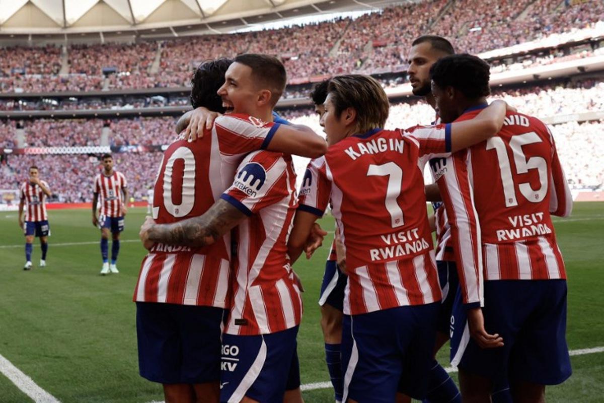 Atletico Madrid's Spanish defender #22 Alejandro Grimaldo (2L) celebrates scoring his team's first goal during the Spanish league football match between Club Atletico de Madrid and Real Madrid CF at the Metropolitano stadium in Madrid on September 20, 2026.  Oscar DEL POZO / AFP