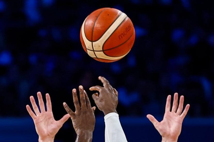 Players jump for the ball in the men's preliminary round group A basketball match between Canada and Australia during the Paris 2024 Olympic Games at the Pierre-Mauroy stadium in Villeneuve-d'Ascq, northern France, on July 30, 2024.  Sameer Al-Doumy / AFP