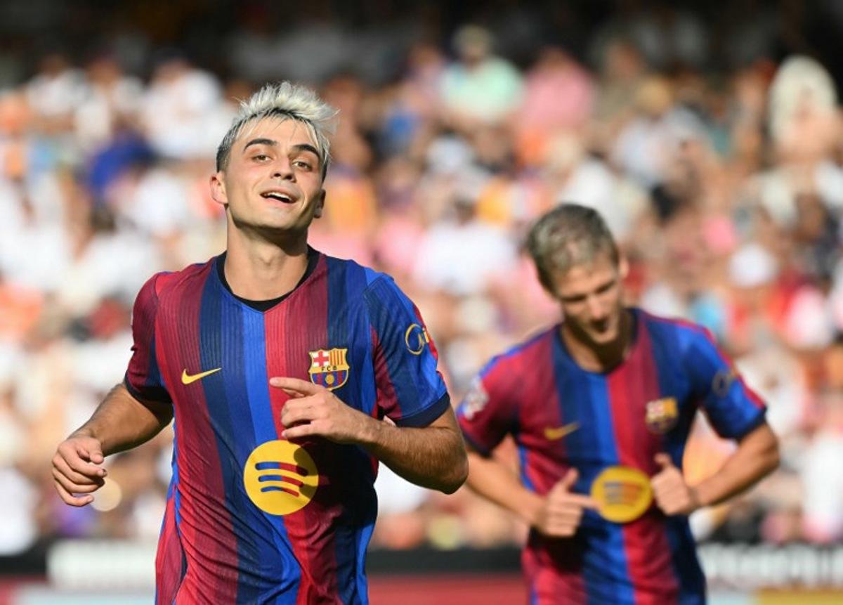 Barcelona's Spanish midfielder #08 Pedri celebrates with teammates scoring his team's fourth goal during the Spanish league football match between Valencia CF and FC Barcelona at Mestalla Stadium in Valencia on September 6, 2026.  JOSE JORDAN / AFP