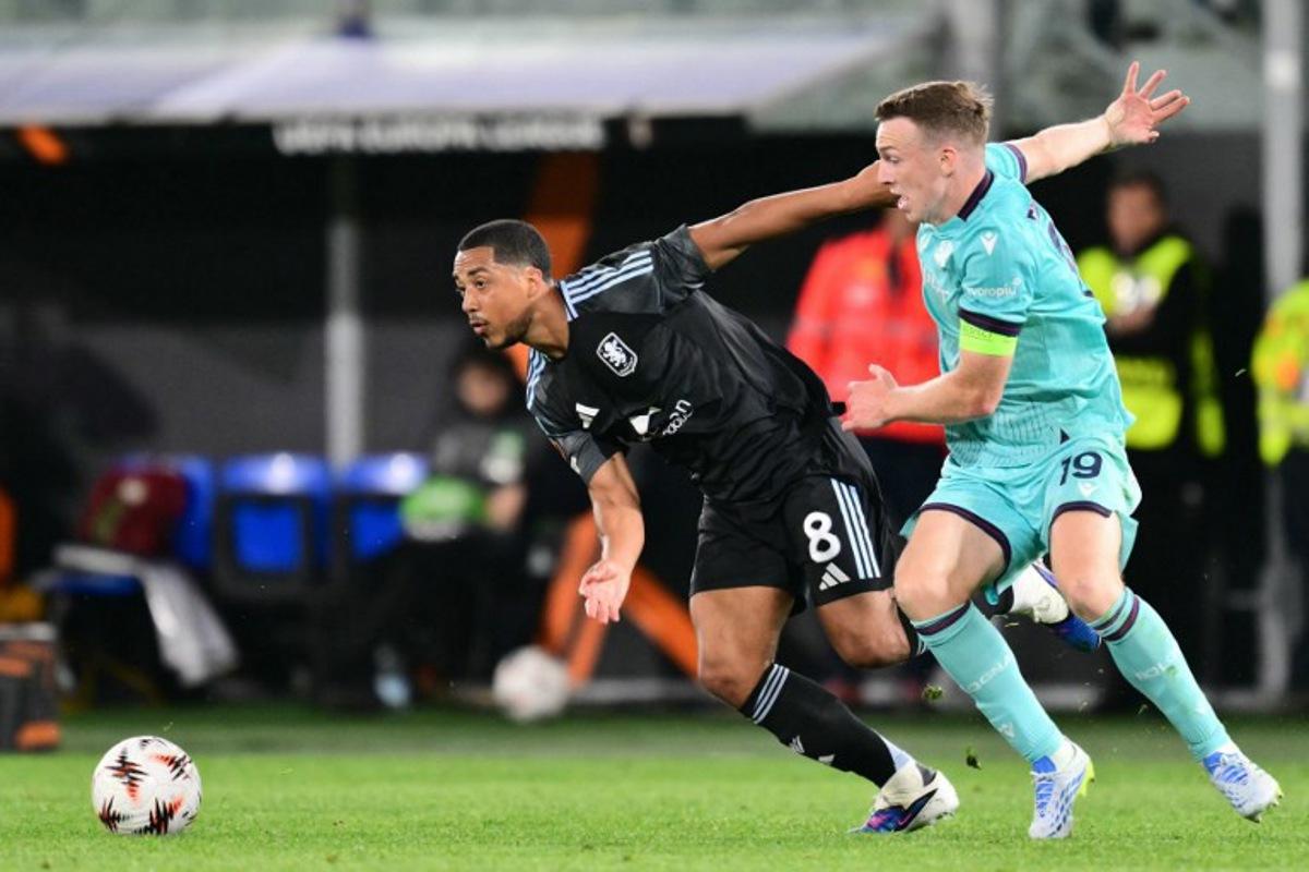 Aston Villa's Belgian midfielder #08 Youri Tielemans fights for the ball with Bologna's Scottish midfielder #19 Lewis Ferguson during the UEFA Europa League quarter final first leg football match between Bologna and Aston Villa at the Renato Dall'Ara stadium in Bologna on April 9, 2026. Stefano RELLANDINI / AFP