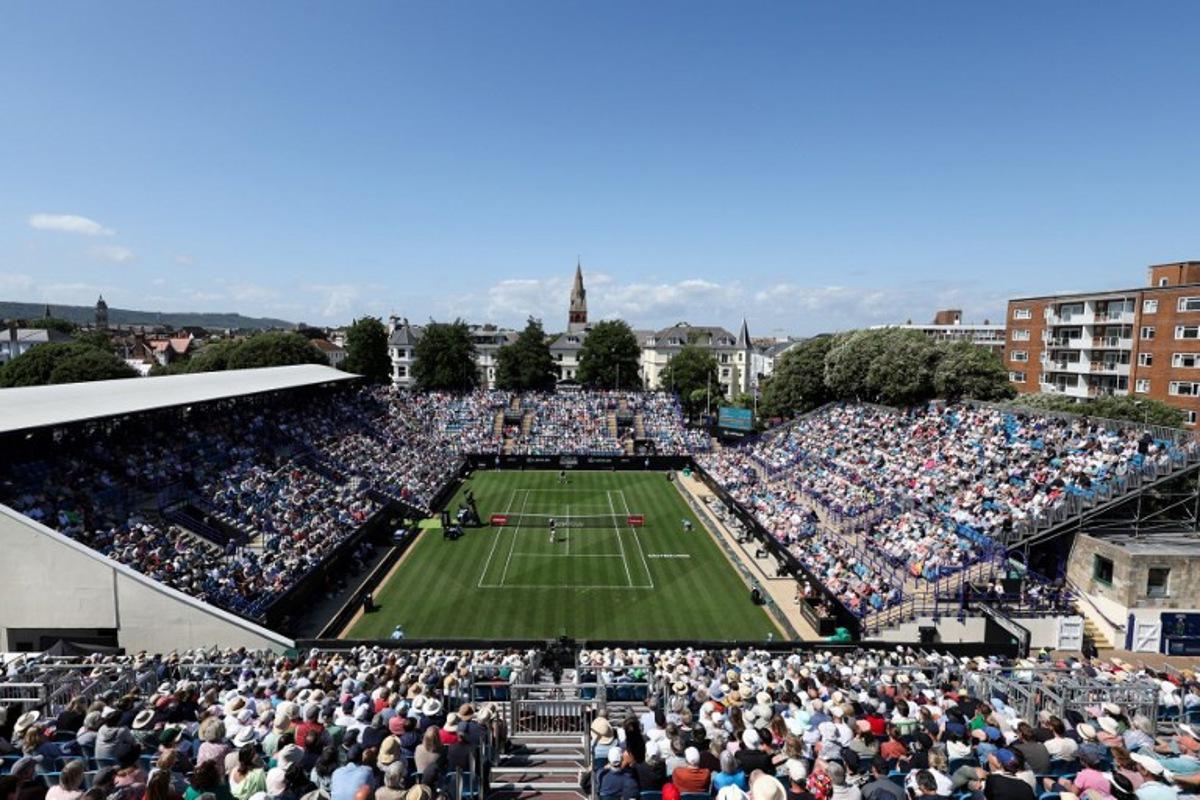 Serbia's Miomir Kecmanovic (down) plays a return to Britain's Daniel Evans during their men's singles tennis match on day one at the Rothesay Eastbourne International tennis tournament in Eastbourne, southern England, on June 23, 2025.  Adrian Dennis / AFP