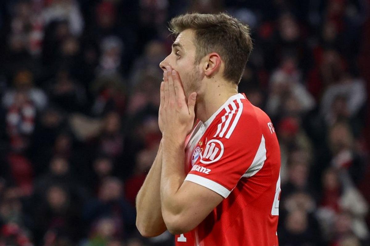 Bayern Munich's Croatian defender #44 Josip Stanisic reacts after a miss during the German first division Bundesliga football match between FC Bayern Munich and Mainz 05 in Munich, southern Germany on December 14, 2025.  Karl-Josef HILDENBRAND / AFP