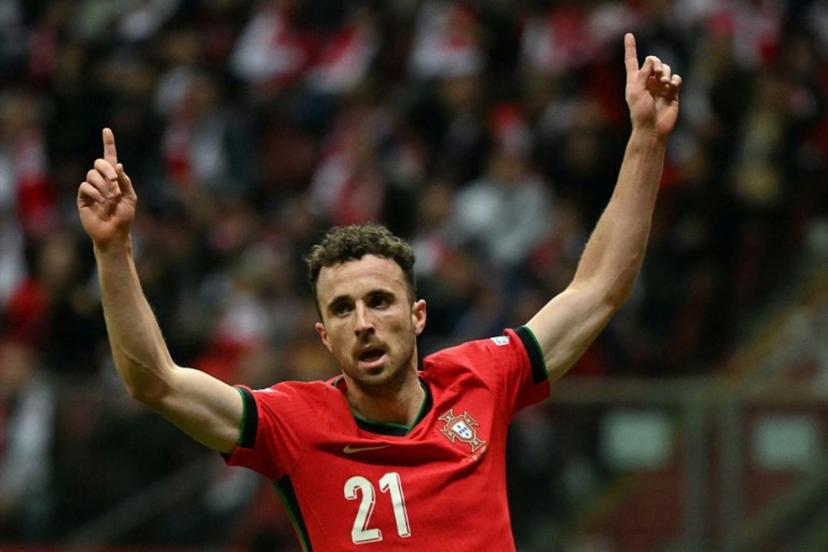 Portugal's forward #21 Diogo Jota reacts after Poland's defender #05 Jan Bednarek scored an own goal during the UEFA Nations League, League A Group A1 football match Poland vs Portugal at the National Stadium in Warsaw, Poland on October 12, 2024.  Sergei GAPON / AFP