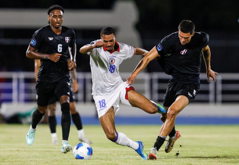 Haiti's forward #18 Wilson Isidor and Dominican Republic's defender #05 Noah Dollenmayer fight for the ball during the Concacaf Nations League Cup football match between Dominican Republic and Haiti at the Felix Sanchez Olympic Stadium in Santo Domingo on October 1, 2026.  Nelson PULIDO / AFP