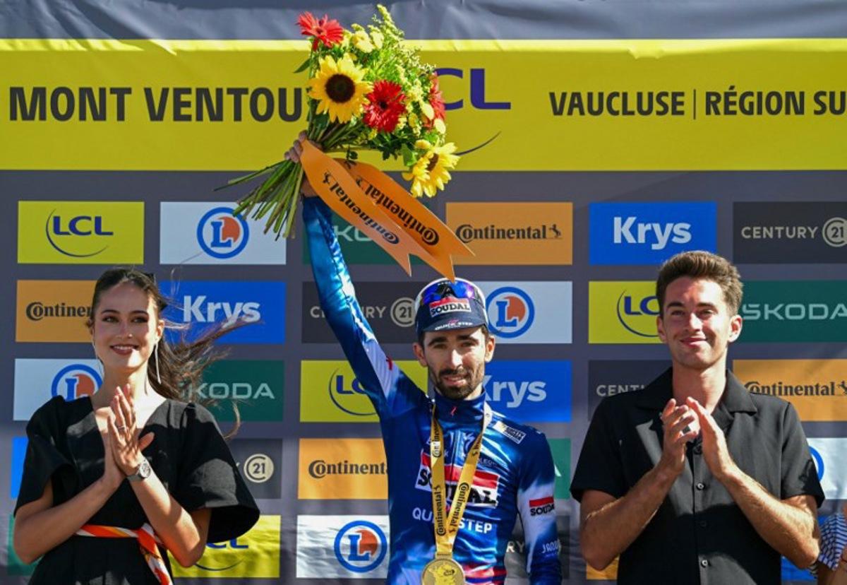 Soudal Quick-Step team's French rider Valentin Paret-Peintre celebrates on the podium after winning the 16th stage of the 112th edition of the Tour de France cycling race, 171.5 km between Montpellier and Mont Ventoux, southern France, on July 22, 2025.  Loic VENANCE / AFP