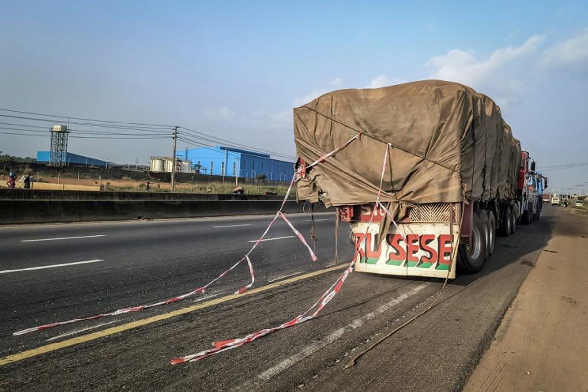 A damaged 18-wheeler truck from a road accident that reportedly involved British boxer Anthony Joshua is towed away on the Lagos-Ibadan Expressway near Sagamu on December 29, 2025. Former world heavyweight champion Anthony Joshua suffered "minor injuries" in a fatal car accident that killed two people on December 29, 2025, Nigerian police said. Pictures circulating online showed a shirtless Joshua, a British national of Nigerian heritage, surrounded by what appeared to be broken window glass on the seats around him. An AFP reporter on the scene saw the 18-wheeler truck that Joshua's car was said to have hit being towed off the highway. Tonye BAKARE / AFP