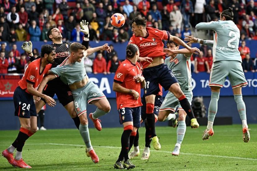 Atletico Madrid's Norwegian forward #09 Alexander Sorloth (3L) collides with Osasuna's Spanish defender #24 Alejandro Catena (L) and Osasuna's Spanish goalkeeper #01 Sergio Herrera Piron during the Spanish league football match between CA Osasuna and Club Atletico de Madrid at El Sadar Stadium in Pamplona, on May 15, 2025.  ANDER GILLENEA / AFP