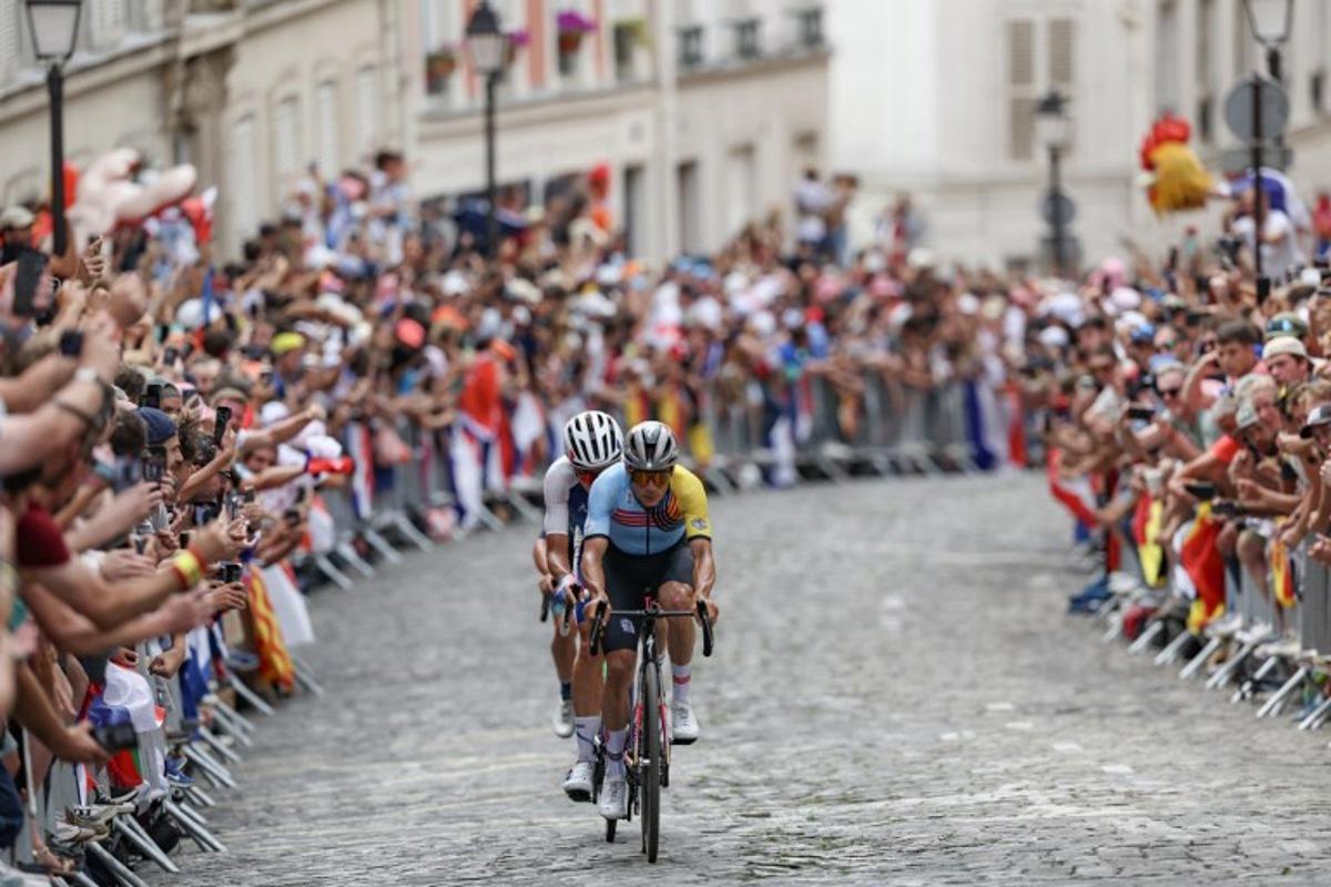 Belgium's Remco Evenepoel cycles ahead of France's Valentin Madouas in the Montmartre ascent during the men's cycling road race during the Paris 2024 Olympic Games in Paris, on August 3, 2024.  Tim De Waele / POOL / AFP