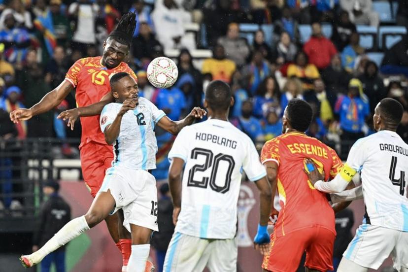 Democratic Republic Of Congo's defender #15 Rocky Bushiri and Botswana's defender #12 Mothusi Johnson vie during the Africa Cup of Nations (CAN) Group D football match between Botswana and Democratic Republic of Congo at El Madina Stadium in Rabat on December 30, 2025.   SEBASTIEN BOZON / AFP