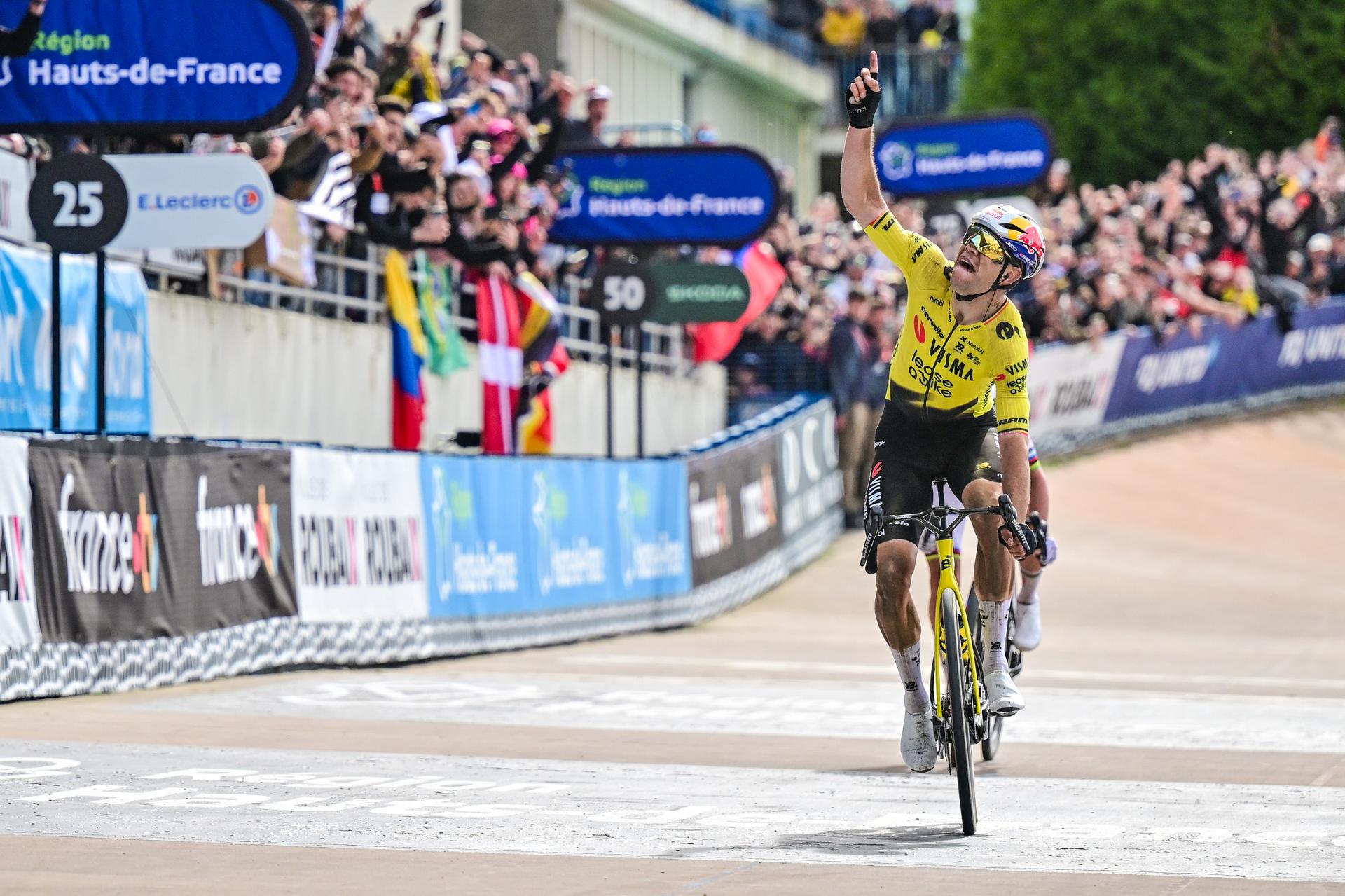 Belgian Wout van Aert of Team Visma-Lease a Bike celebrates as he crosses the finish line to win the men's Paris-Roubaix cycling race, Sunday 12 April 2026, around Roubaix, France. The 123rd edition of Paris-Roubaix cycling races will take on Sunday, with the women riding 143,1 km the men riding 258,3 km on Sunday. BELGA PHOTO JASPER JACOBS