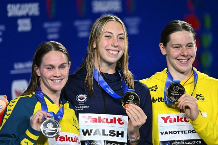 (L-R) Silver medallist Australia's swimmer Jamie Perkins, gold medallist US' swimmer Gretchen Walsh, and bronze medallist Belgium's swimmer Roos Vanotterdijk celebrate on the podium of the women's 50m butterfly swimming event during the 2025 World Aquatics Championships in Singapore on August 2, 2025.   MANAN VATSYAYANA / AFP