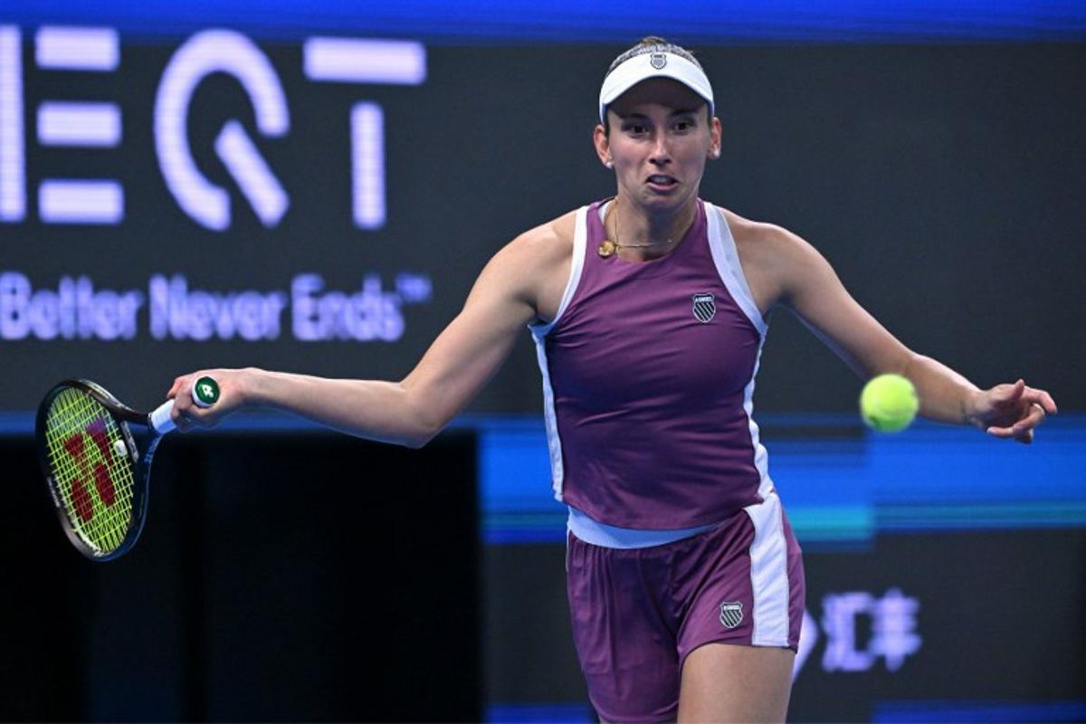 Belgium's Elise Martens hits a return to China's Zheng Qinwen during their semi-final match at the China Open tennis tournament in Beijing on October 10, 2026.  ADEK BERRY / AFP