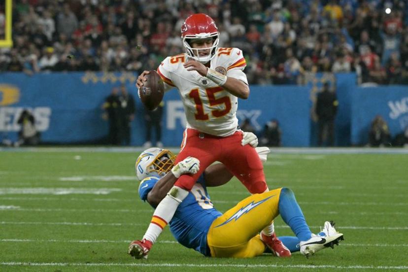 Kansas City Chiefs' quarterback #15 Patrick Mahomes is tackled by Los Angeles Chargers' linebacker #0 Daiyan Henley during the NFL game between the Kansas City Chiefs and Los Angeles Chargers at the Neo Quimica Arena Stadium in Sao Paulo, Brazil, on September 5, 2025.  NELSON ALMEIDA / AFP