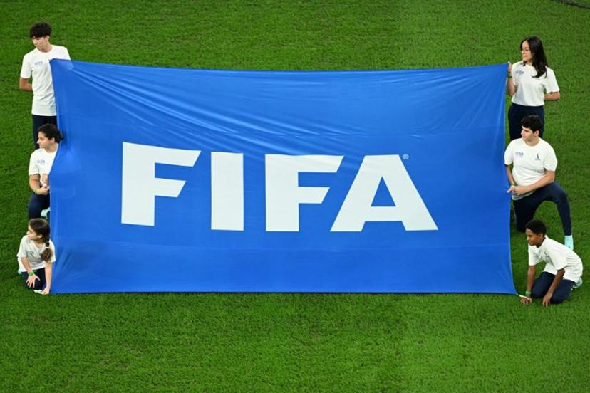 Volunteers display a FIFA banner before the start of the Qatar 2022 World Cup quarter-final football match between Croatia and Brazil at Education City Stadium in Al-Rayyan, west of Doha, on December 9, 2022.  Ina Fassbender / AFP