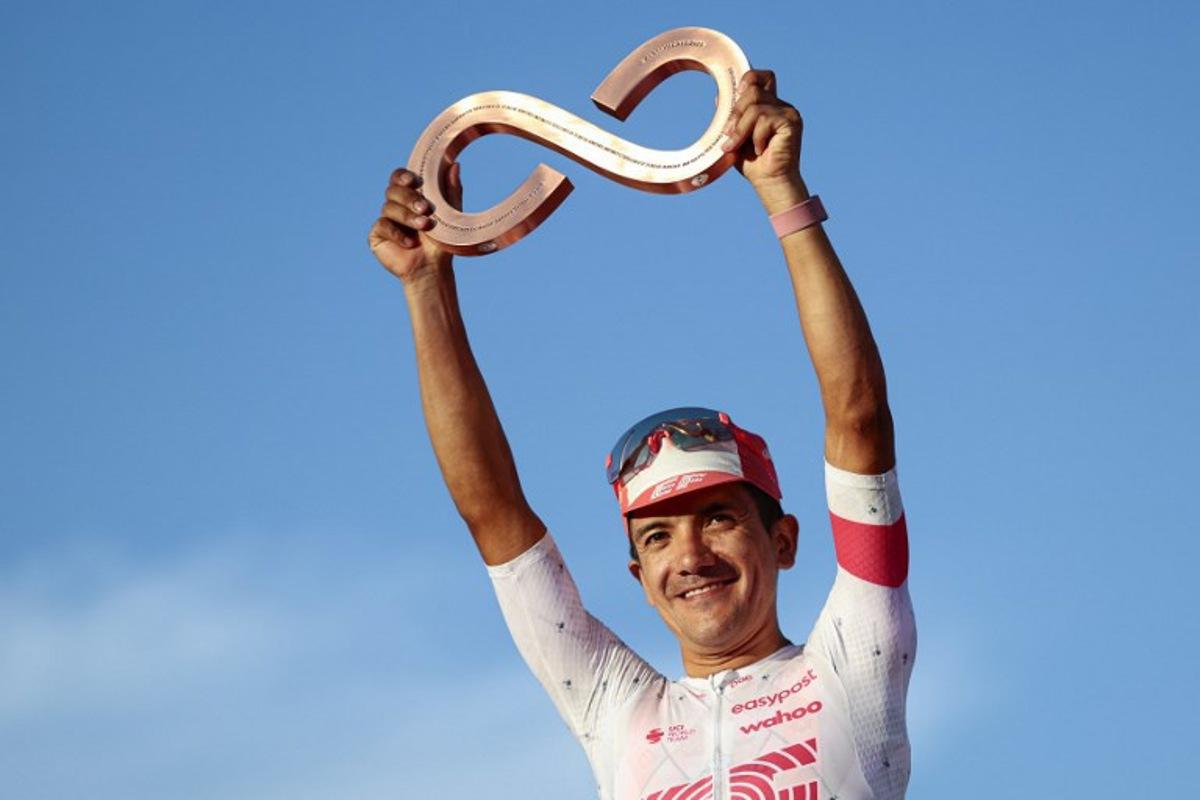 Third placed EasyPost's Ecuadorian rider Richard Carapaz celebrates on the podium after the 21st and last stage of the 108th Giro d'Italia cycling race of 143kms from Rome to Rome on June 1, 2025.  Luca Bettini / AFP